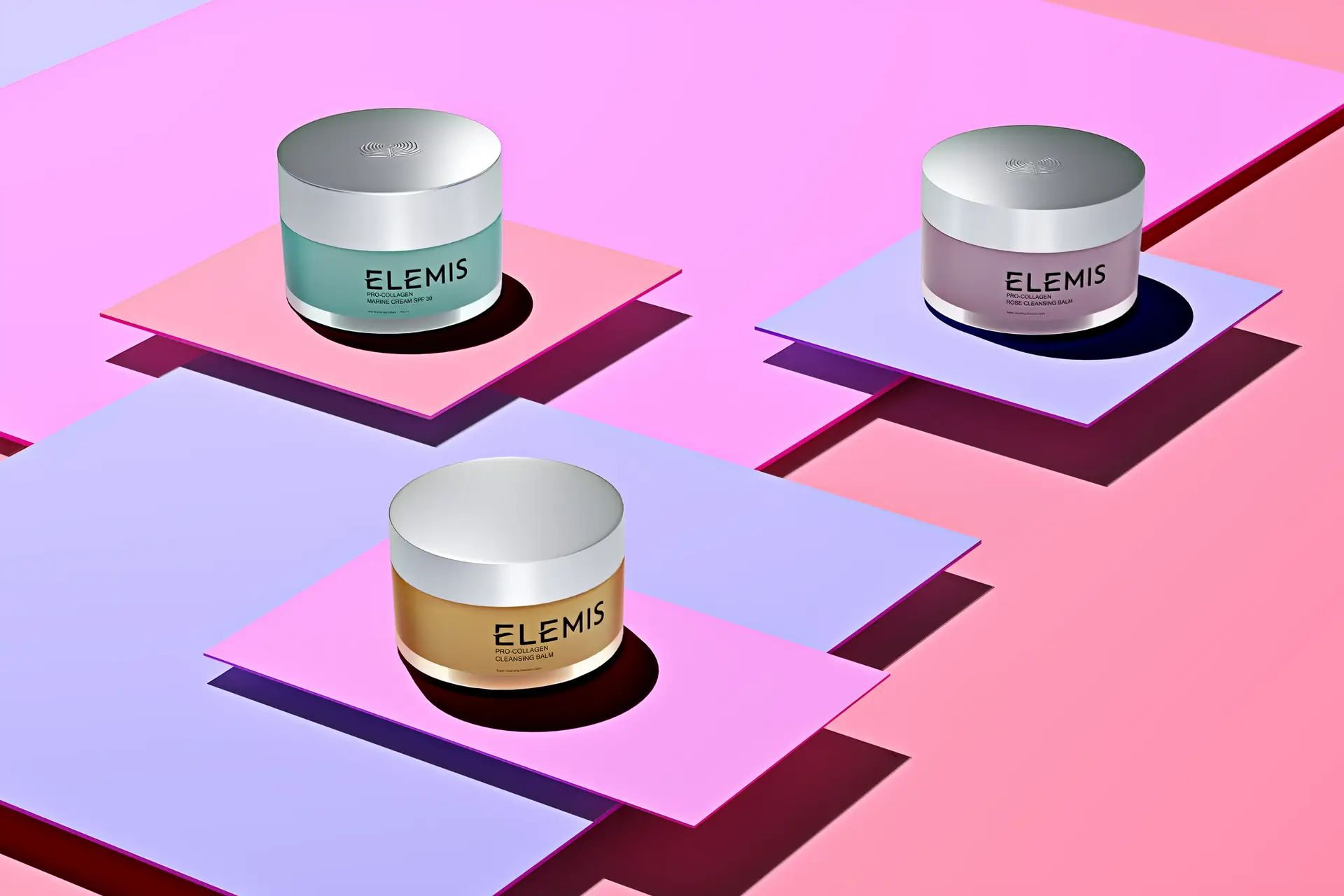 Three Elemis skincare jars styled on pastel geometric platforms for a cosmetics product shoot