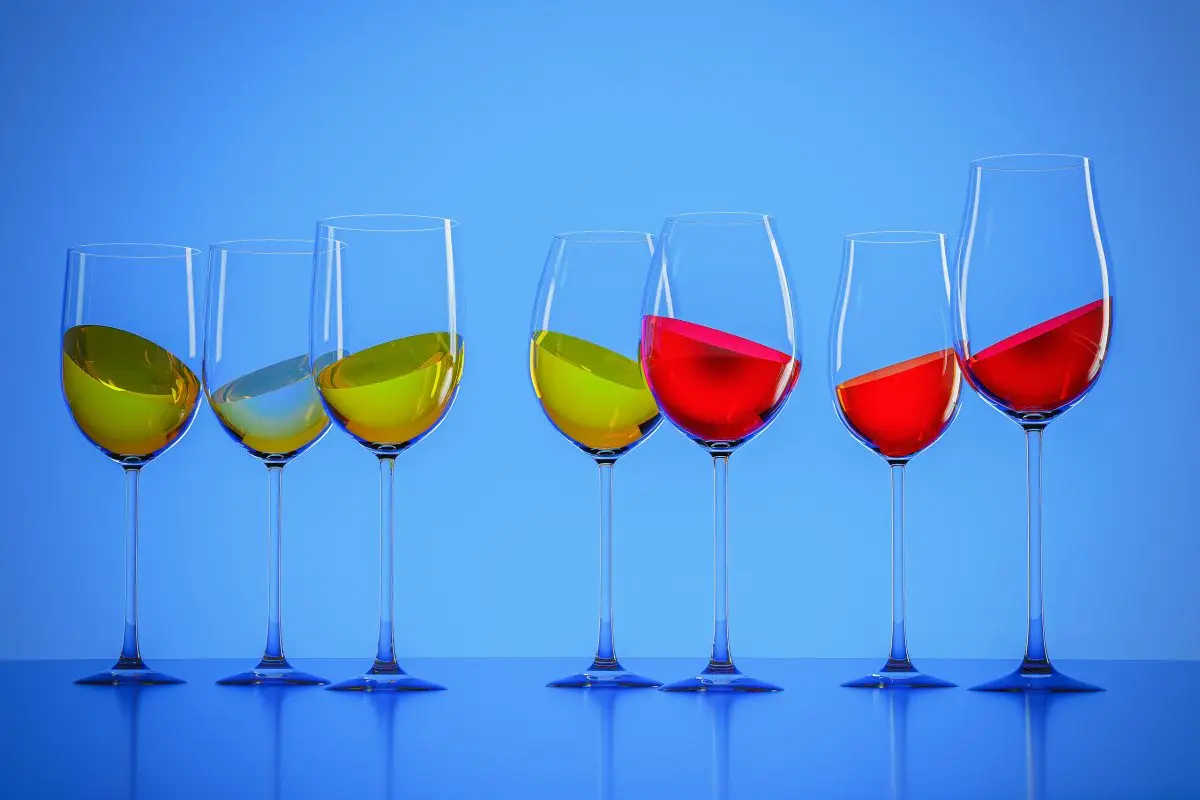 Seven wine glasses filled with white, rose and red wine against a blue gradient background