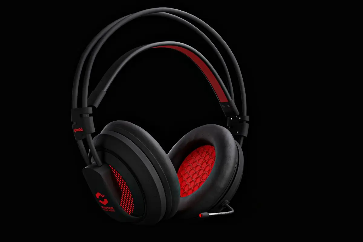 Black and red gaming headset with boom microphone on a dark background