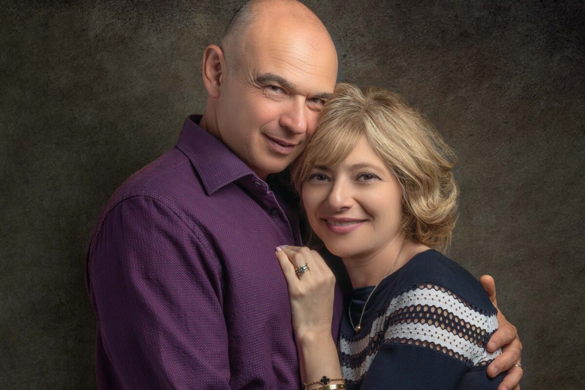 Couple embracing and smiling in a studio portrait