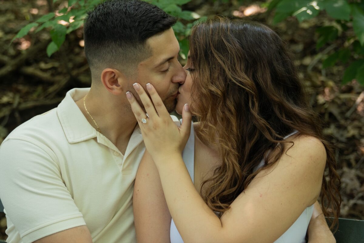 Couple sharing a kiss during an outdoor engagement session