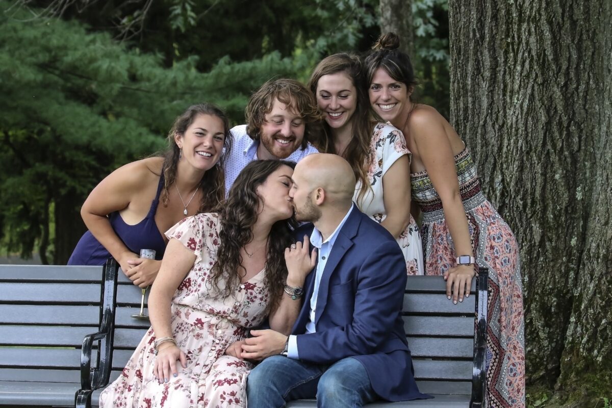 Engaged couple sitting together at their outdoor engagement party