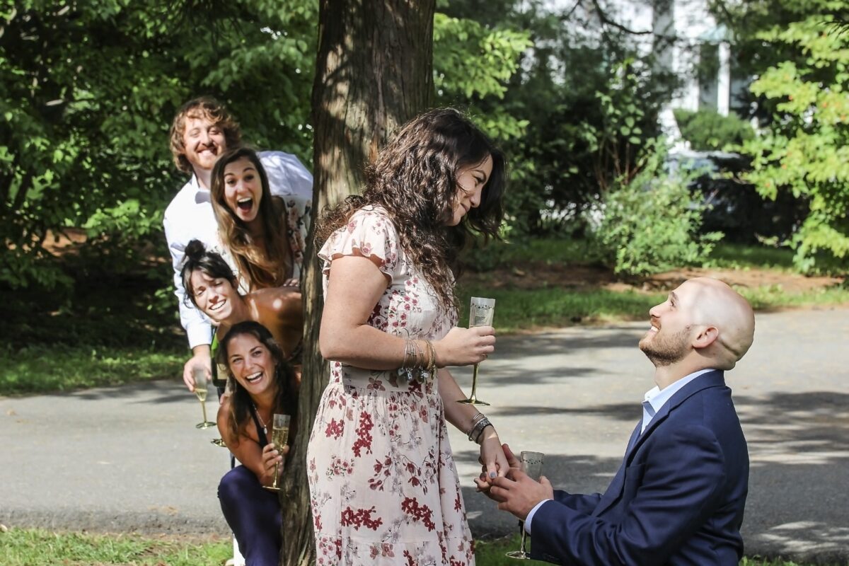 Man kneeling to propose in a garden