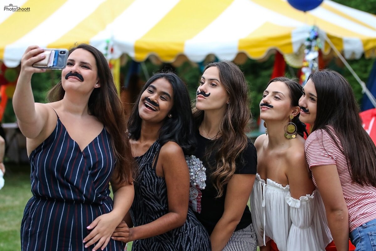 Friends laughing together at an outdoor summer party
