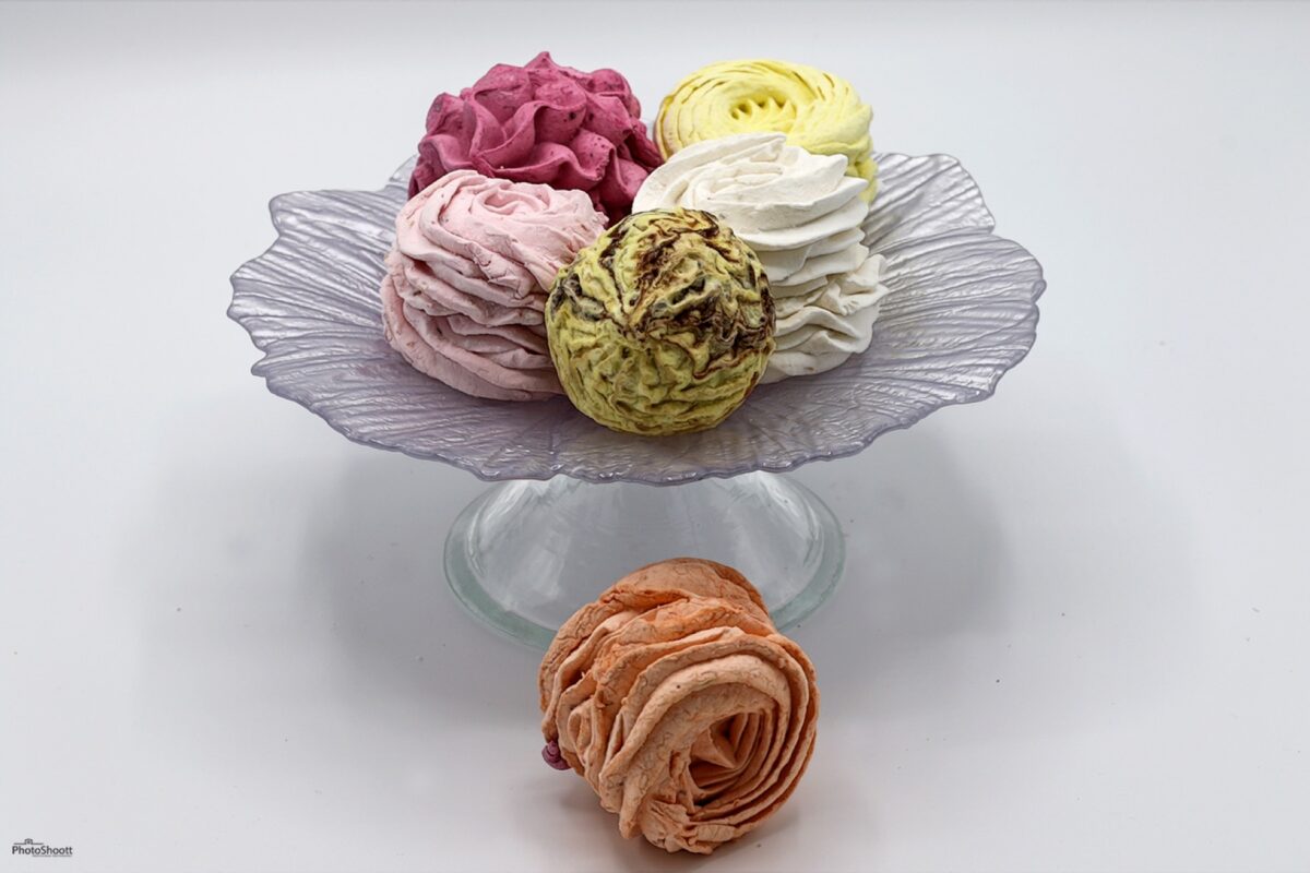 Pastel zephyr confections on a glass cake stand