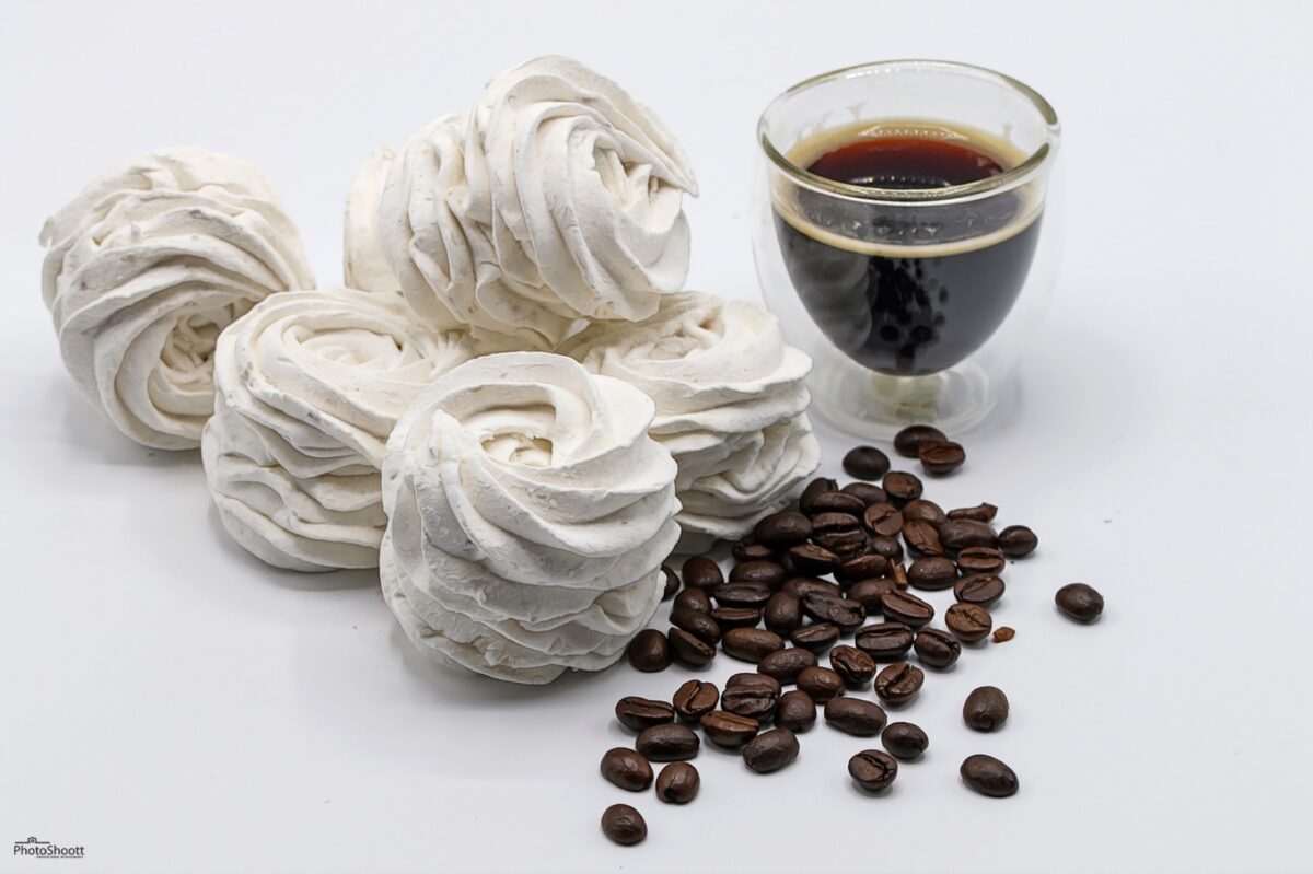 Coffee zephyr confections with coffee beans and an espresso cup
