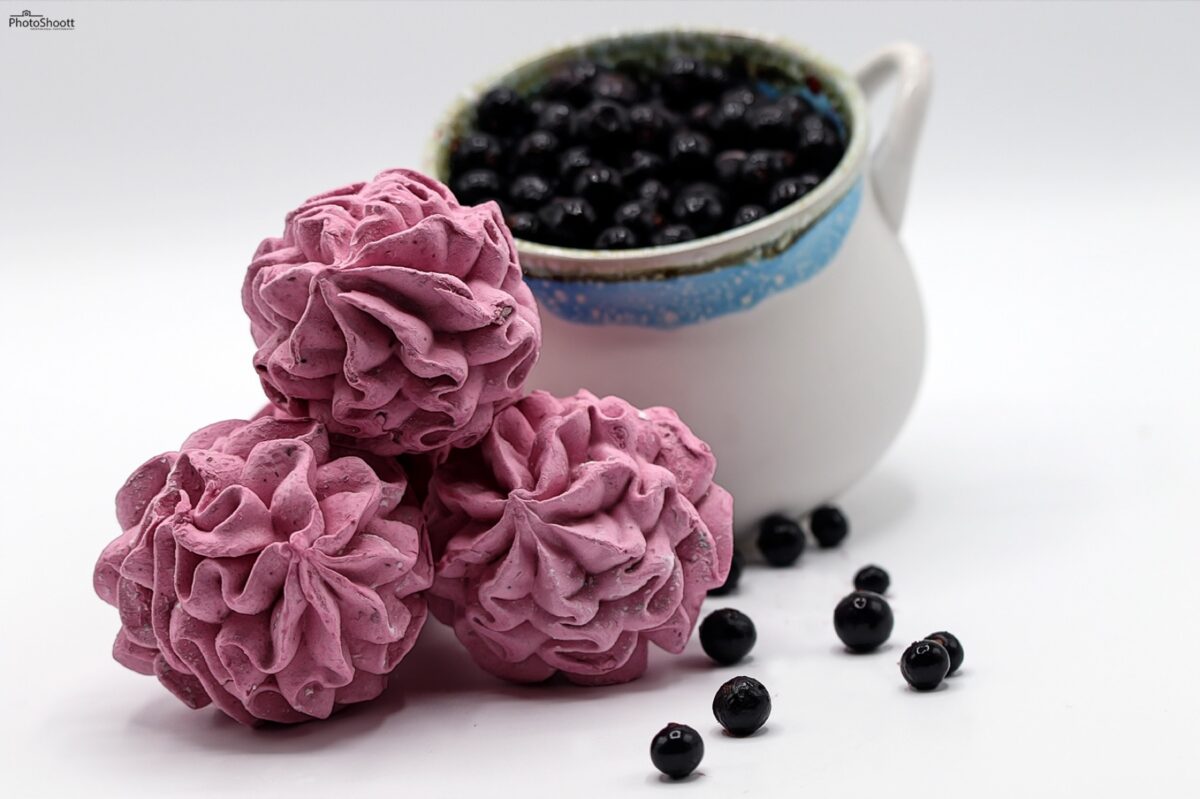 Blackcurrant zephyr confections with a jug of berries