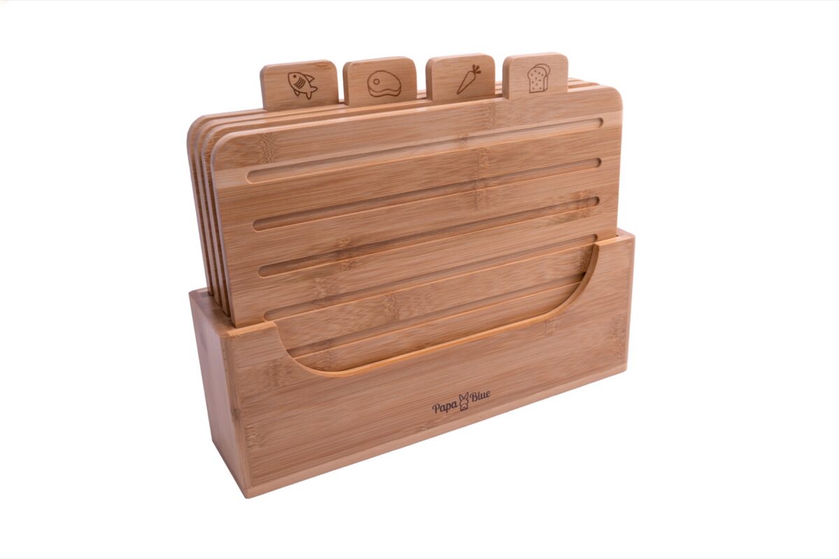 Bamboo cutting boards in a stand on a white background