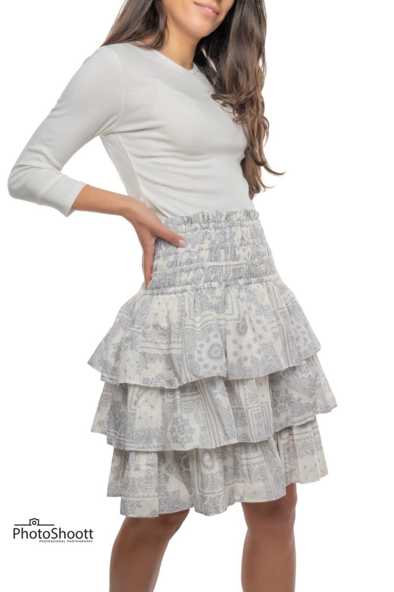 Tiered white skirt on a model for an apparel catalog