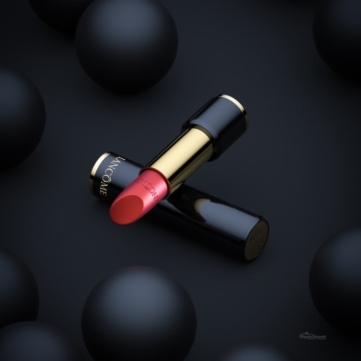Lancome lipstick among black spheres