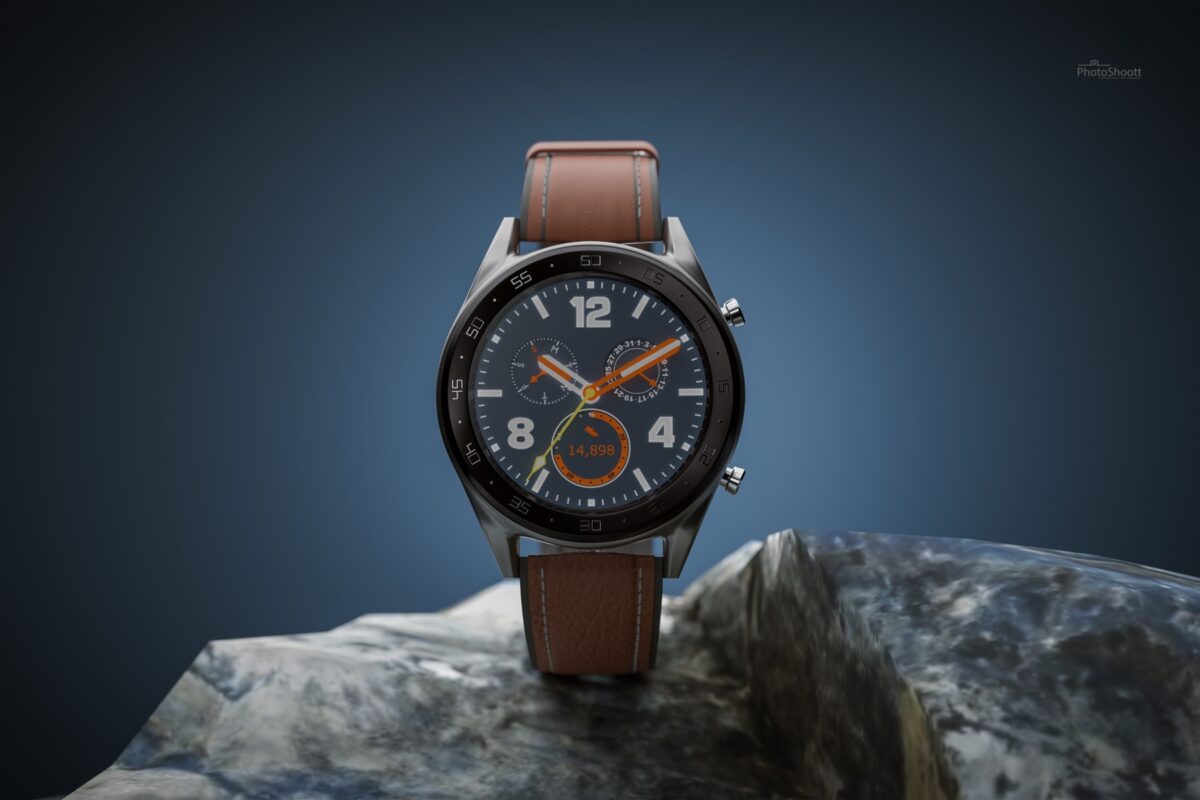 Leather-strap wristwatch on a rock against a blue backdrop