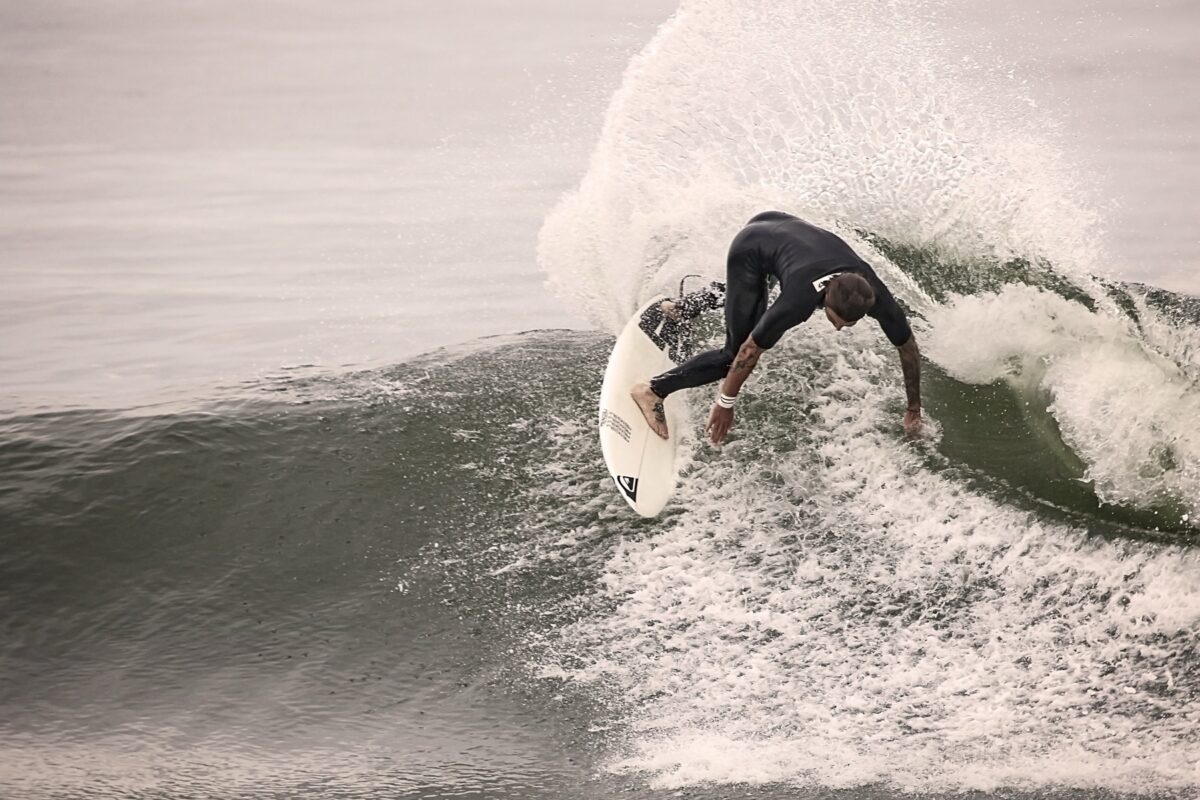 Surfer carving through spray on a wave
