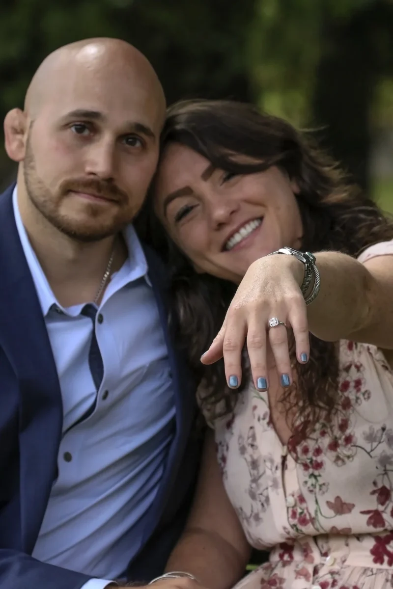 Engaged couple showing off the ring at their engagement party