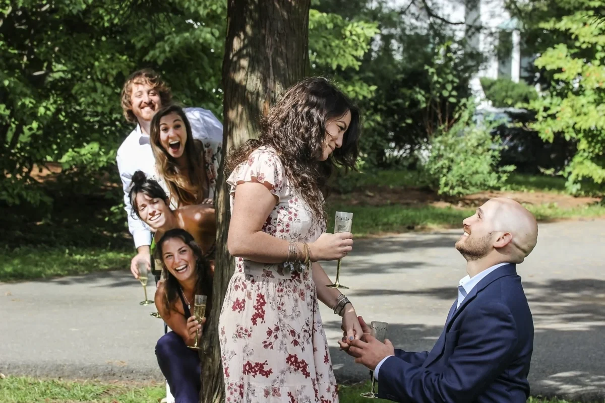 Man kneeling to propose in a garden