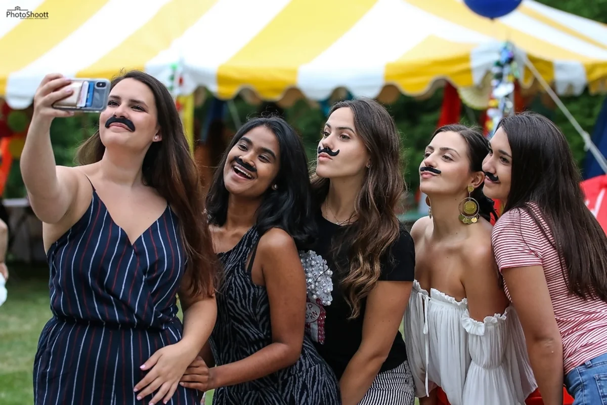 Friends laughing together at an outdoor summer party