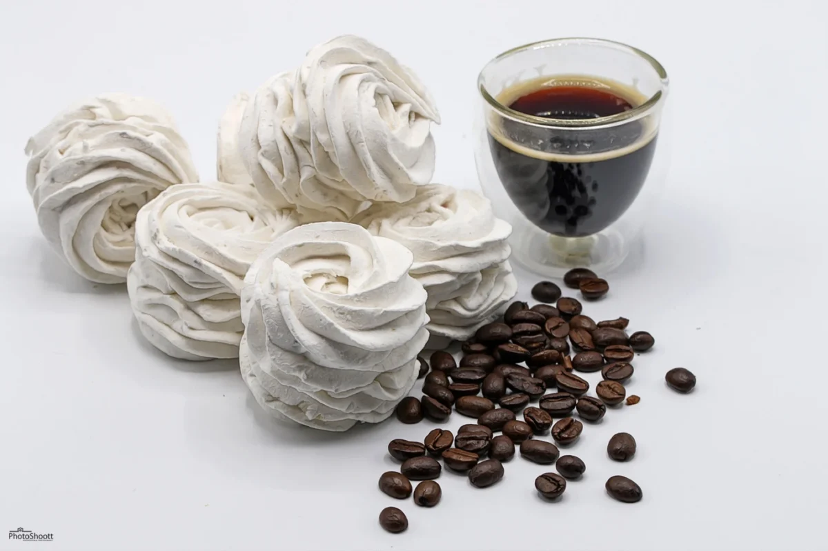 Coffee zephyr confections with coffee beans and an espresso cup