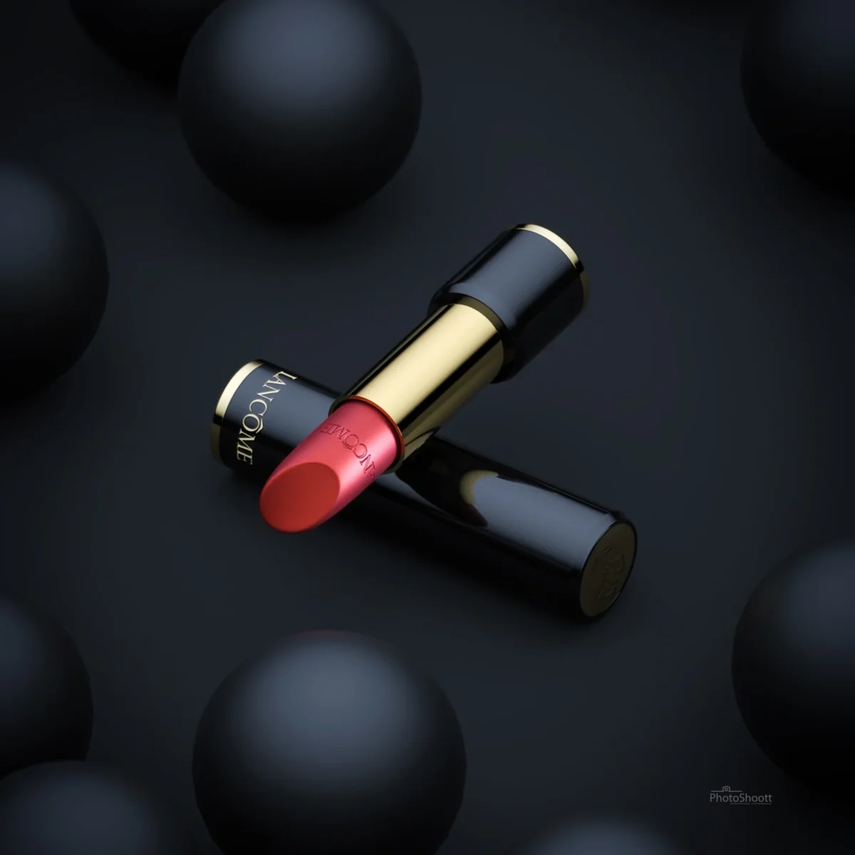 Lancome lipstick among black spheres
