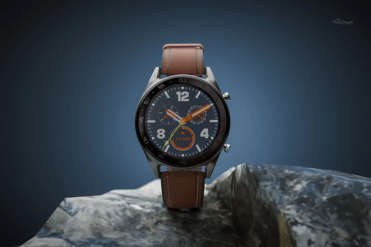 Leather-strap wristwatch on a rock against a blue backdrop