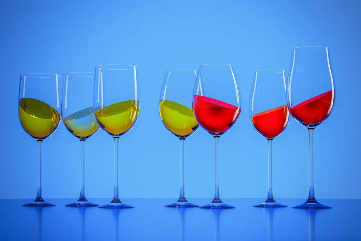 Seven wine glasses filled with white, rose and red wine against a blue gradient background