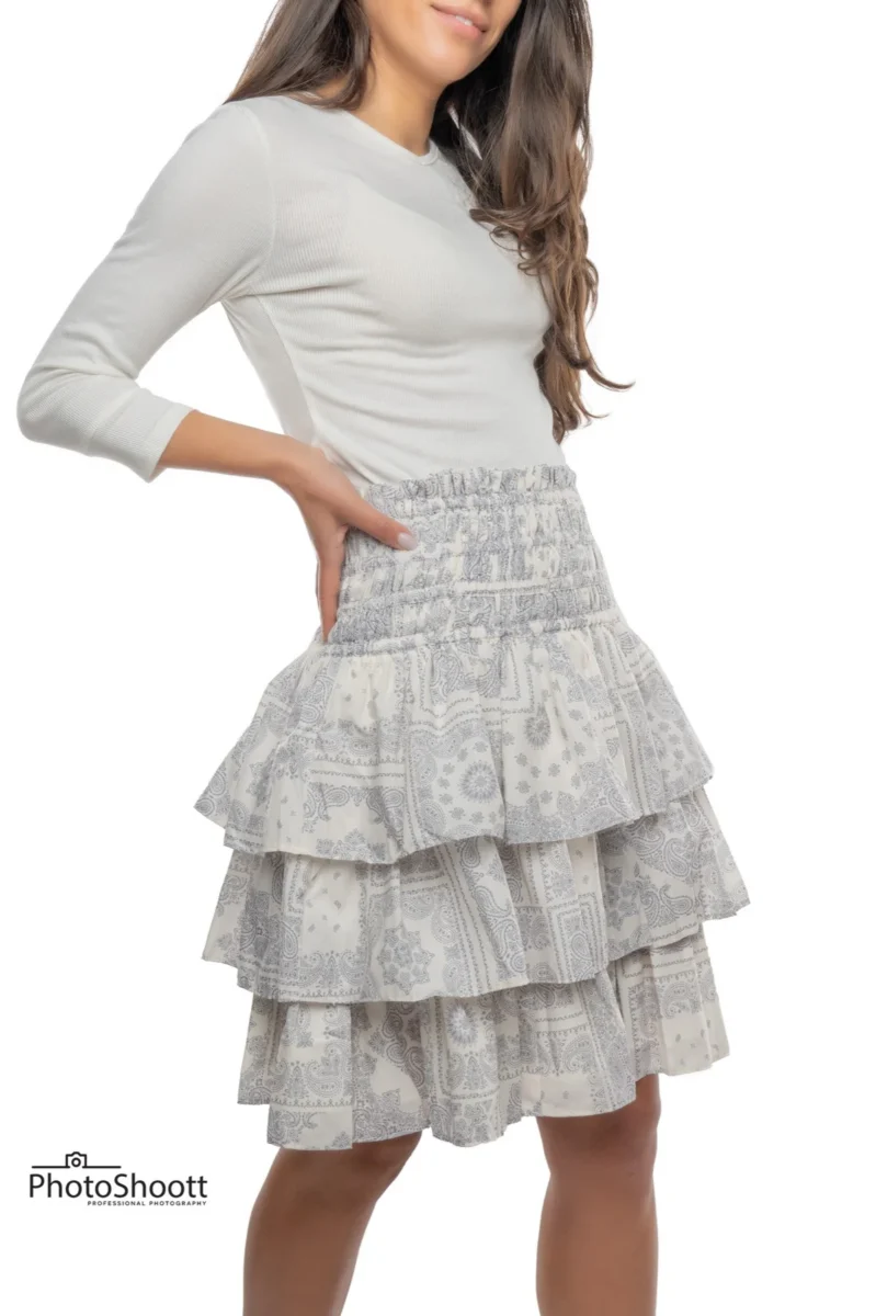 Tiered white skirt on a model for an apparel catalog