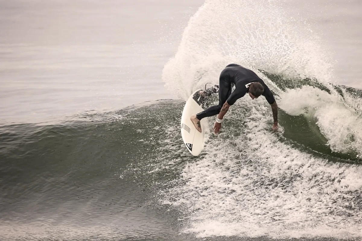 Surfer carving through spray on a wave